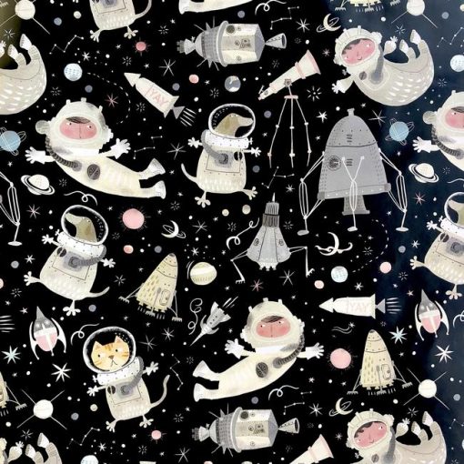 Close up of gift wrap pattern of a boy, cat, and dog in space suits, floating through outer space with rockets, space ships, planets, and stars.