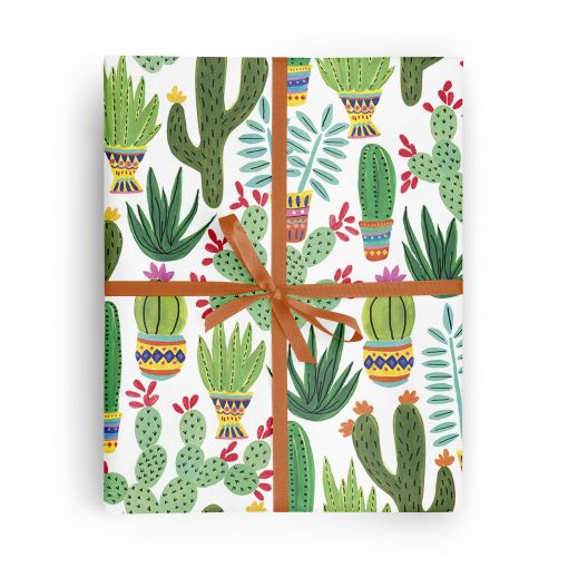 Flat box wrapped in gift wrap pattern of succulents and cactuses on a white background.