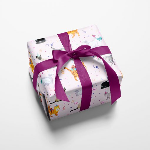 Gift wrapped box with whimsical kitties in party hats are surrounded by falling confetti on a pretty pink background.