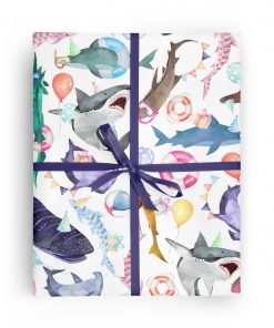 Flat box wrapped in gift wrap pattern of great white sharks, hammerhead sharks, and a variety of other shark species wearing party hats and sunglasses and carrying balloons and gifts.