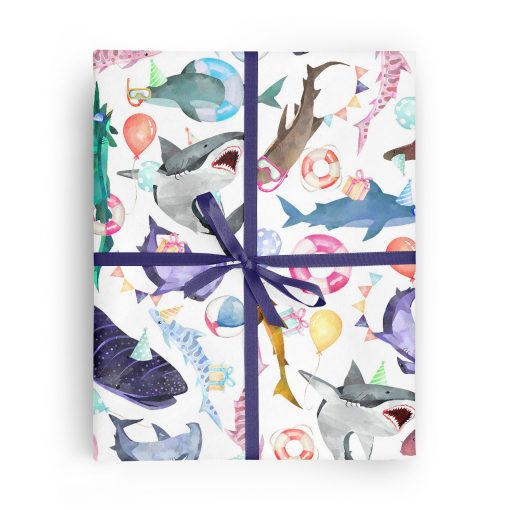 Flat box wrapped in gift wrap pattern of great white sharks, hammerhead sharks, and a variety of other shark species wearing party hats and sunglasses and carrying balloons and gifts.