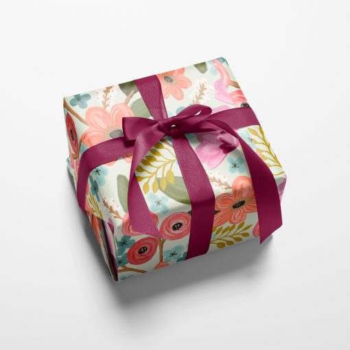 Gift wrapped box with beautiful and feminine flowers in a romantic pastel color palette.